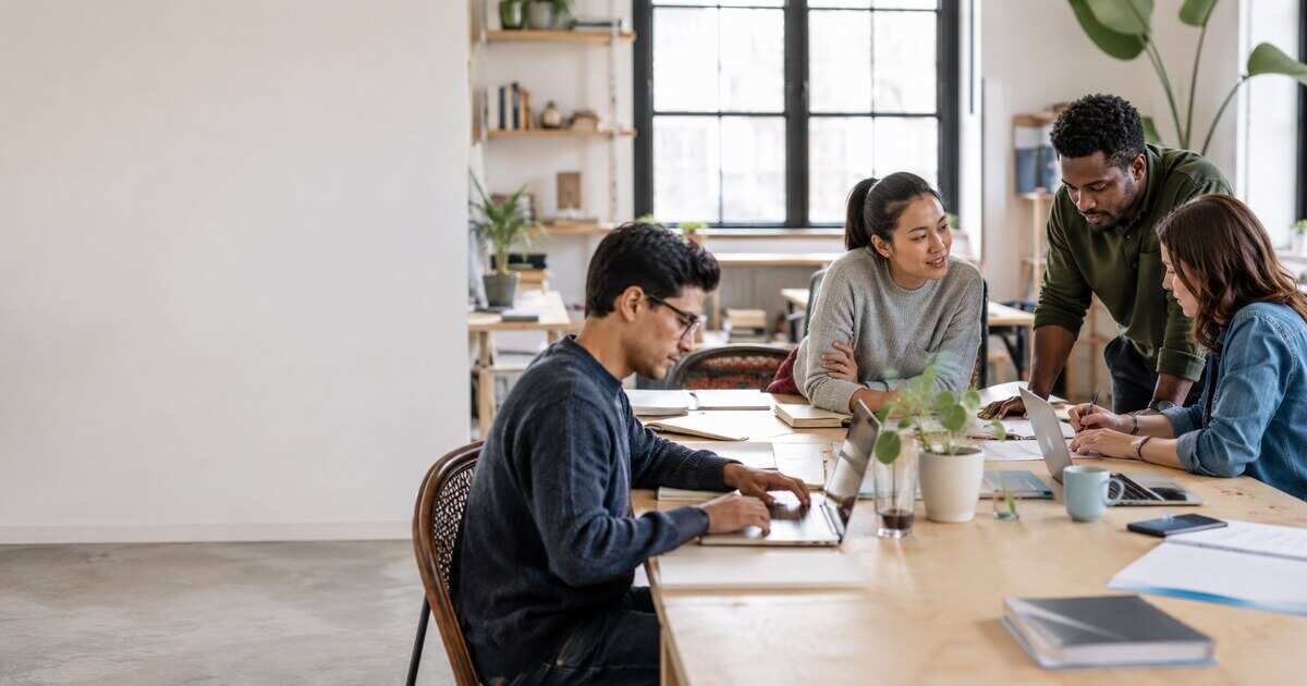 A team member balancing focused work and collaboration at a modern desk